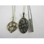 Three white metal pendant necklaces, one of reticulated rectangular form set with paste stones,