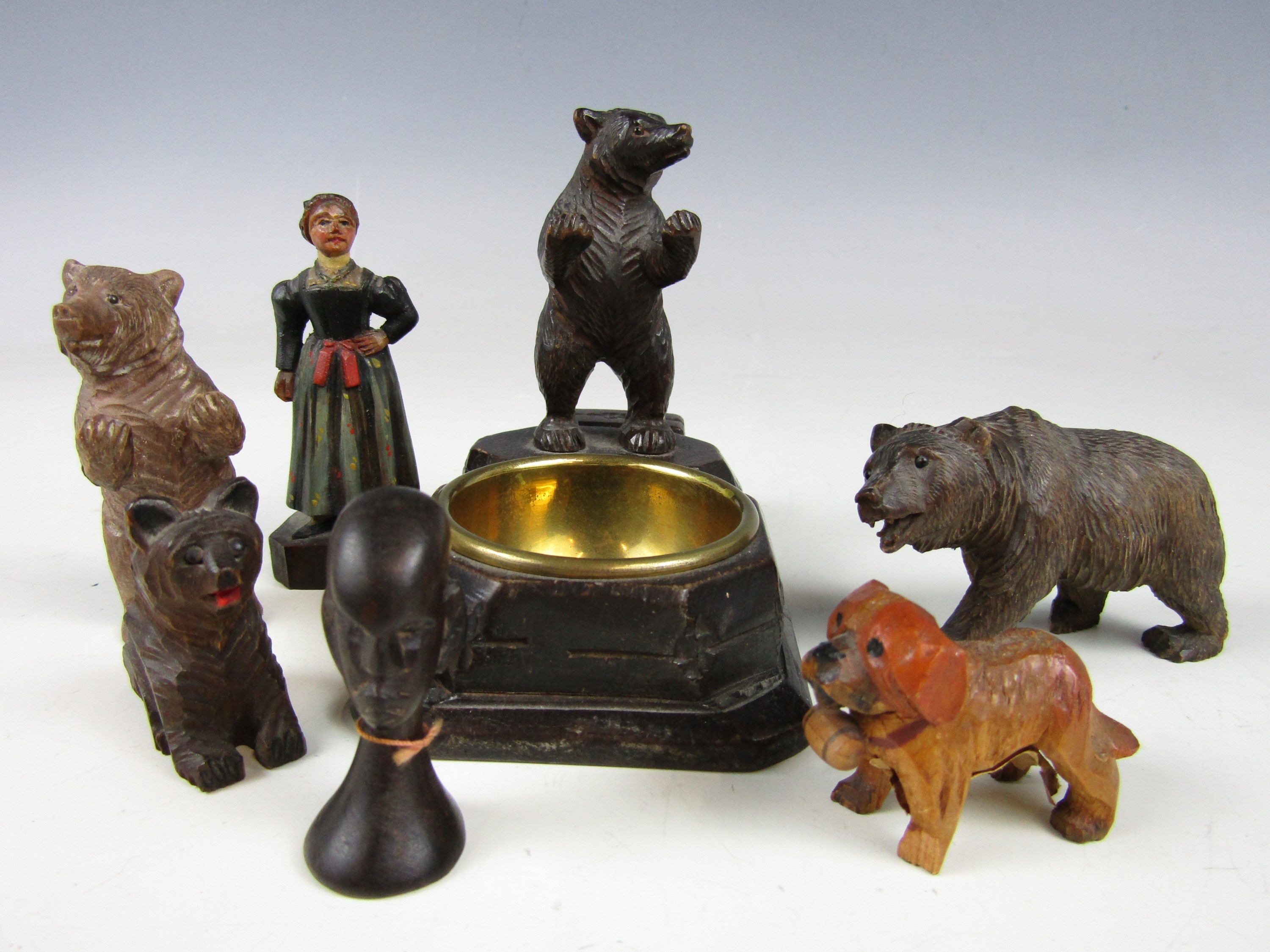 A Black Forest carved ashtray from Engelberg, together with sundry carved bears and a hand made