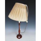 A turned wooden baluster table lamp
