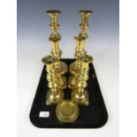 Three pairs of brass candlesticks together with two brass weights