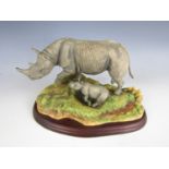 A Border Fine Arts figurine depicting a rhino and calf (a/f)