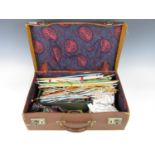 A vintage hide case containing sundry sewing and knitting accessories