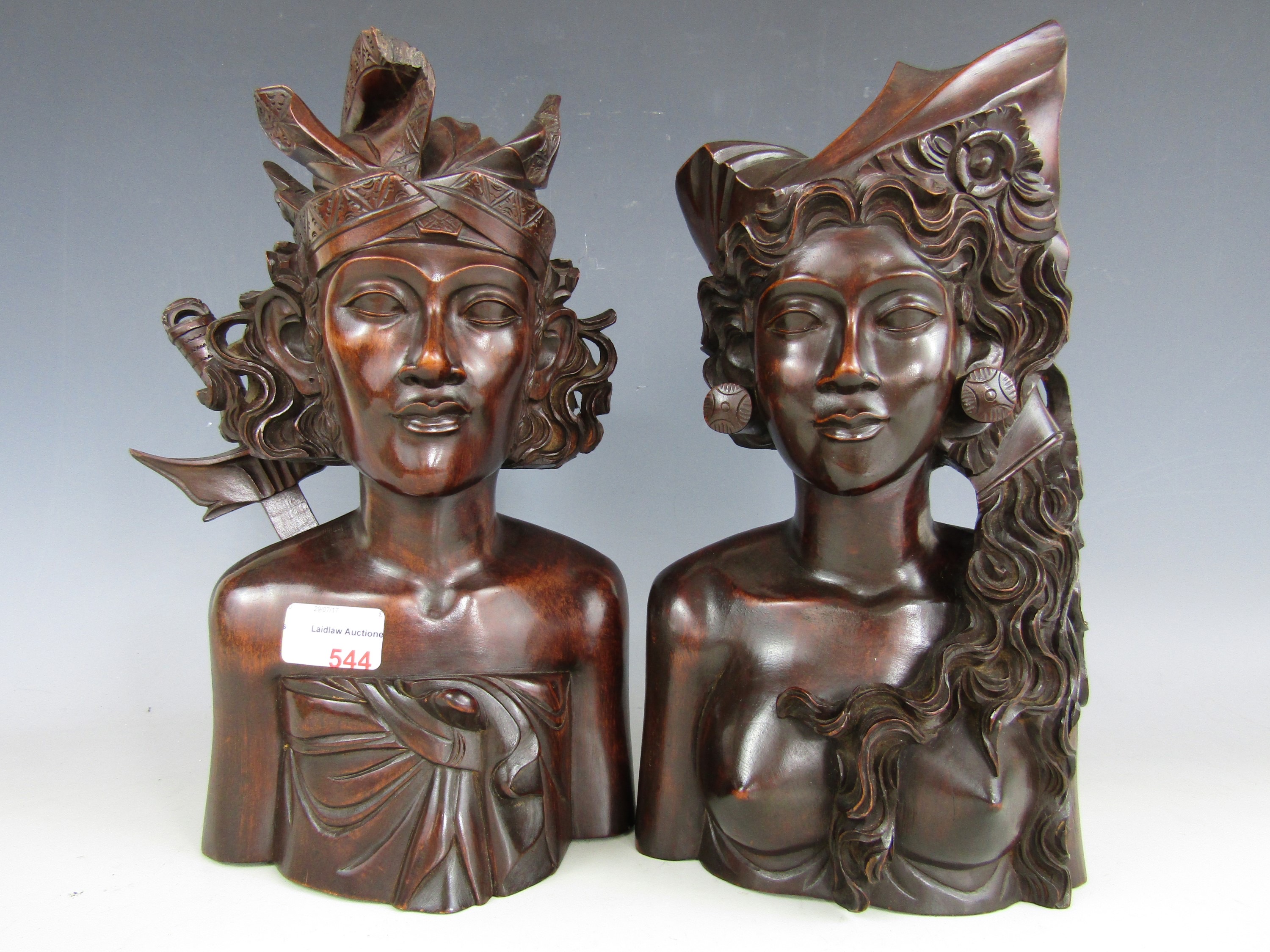 A pair of Balinese busts (one a/f)