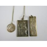 A silver ingot pendant together with two further white-metal religious iconographic pendants, both