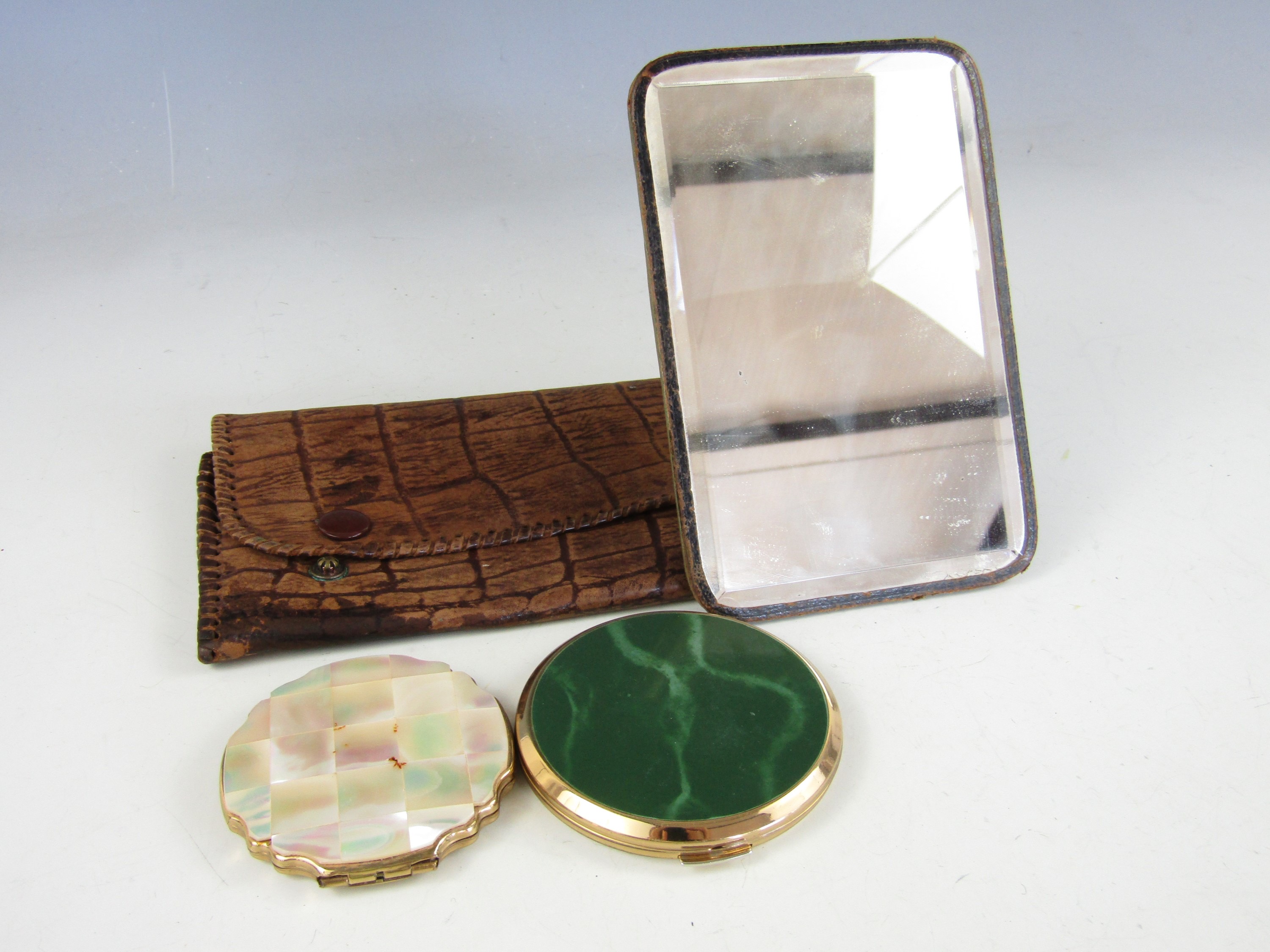 Two vintage Stratton compacts together with a cased dressing mirror