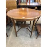 An Edwardian cross-banded and string-inlaid mahogany oval occasional table