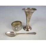 A silver spoon together with a silver napkin ring and bud vase