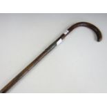 An antique silver-collared palm wood walking cane