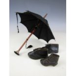 A doll's parasol together with a pair of doll's shoes and one other