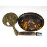 A 1920s faux-tortoiseshell dressing table set, comprising tray, hand mirror and clothes brush