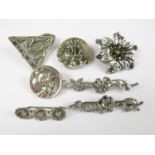 Early 20th Century Art Nouveau white metal and electroplate brooches, including three floral bar