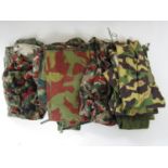 A quantity of military camouflage and olive drab clothing