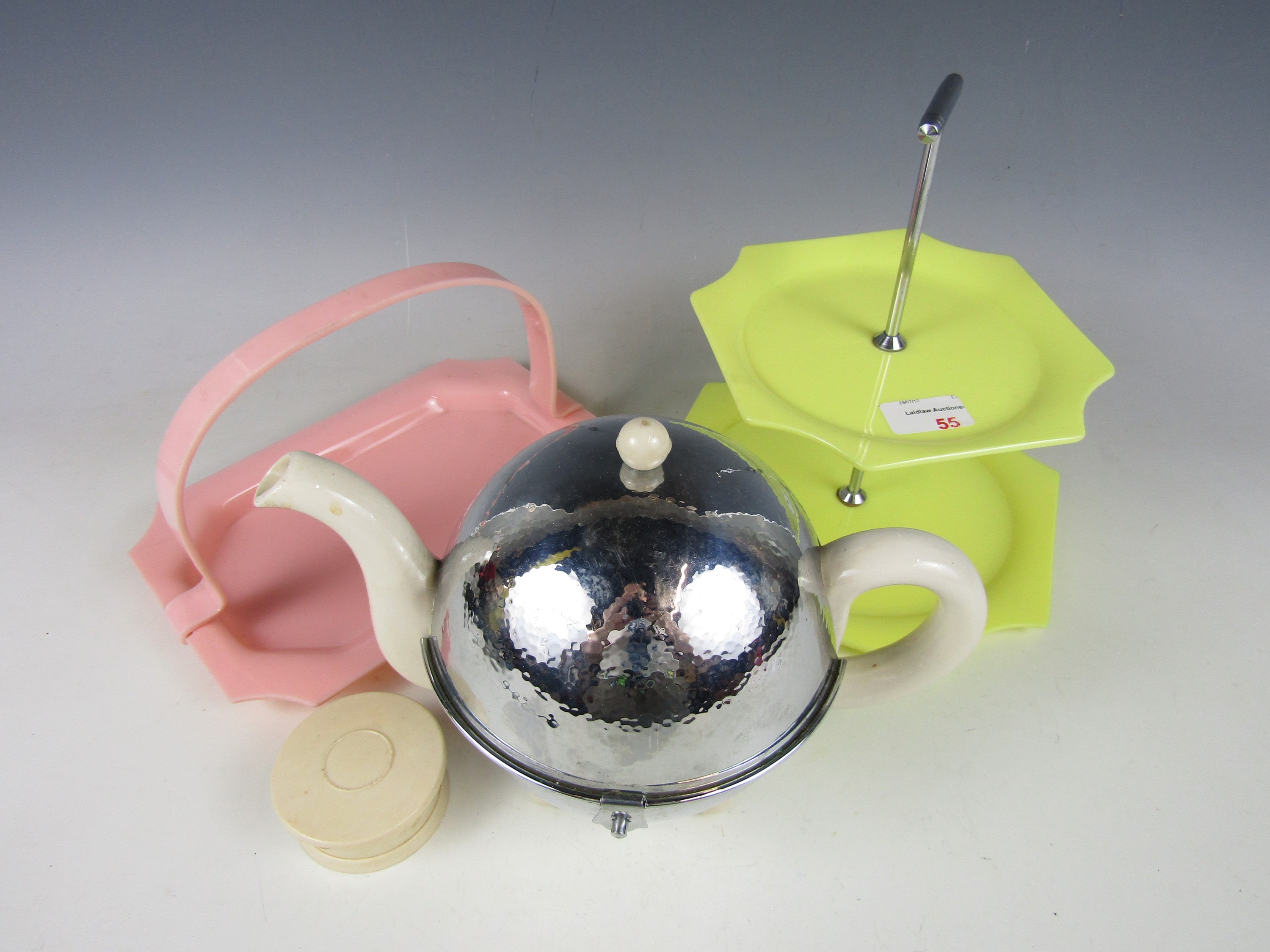 A mid 20th century Lucite cake stand together with basket, a collapsible cup and an insulated