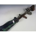 A quantity of vintage hickory-shafted and other golf clubs, together with a green tartan golf bag