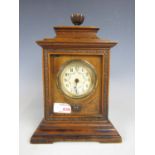 A late 19th century walnut-cased mantel clock with later quartz movement