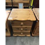 A pine three drawer bedside chest, 45 x 40 x 59 cm