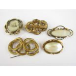 Victorian rolled gold brooches, including one centrally set with a pivoting locket