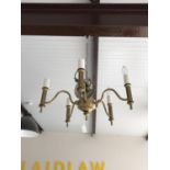 A contemporary brass five-branch ceiling light