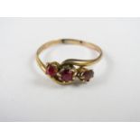 A vintage 9ct gold and three stone garnet dress ring