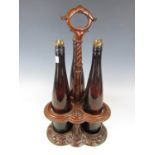 A Victorian carved mahogany decanter stand with bottles