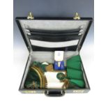A vintage briefcase containing Masonic regalia including a cased set of Masonic cuff links