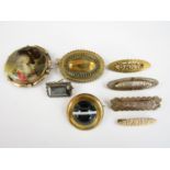 19th Century and later gilt metal brooches, including a 'Mizpah' brooch and two 'Baby' brooches