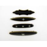 Four late 19th / early 20th Century black enamelled bar brooches, three set with split seed pearls