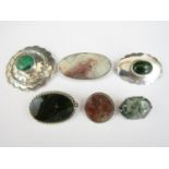 Six vintage hardstone brooches set in white metal, stamped silver