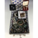 A vintage vanity box containing a large quantity of assorted vintage and modern costume jewellery