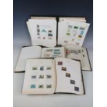 Four early 20th Century philatelic albums containing collections of postage stamps on animals,