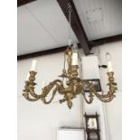 A reproduction brass three-branch ceiling light