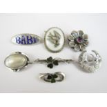 Victorian white metal brooches, including one champlevé enamelled 'Baby' brooch, together with one