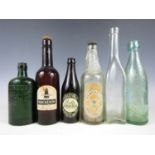 Six vintage glass bottles including Mackeson Stout, Newcastle Light Ale and Richardson's Newcastle
