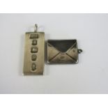 A silver ingot pendant together with a silver fob stamp box, 35.9g total