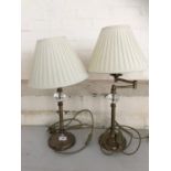 A pair of brass and glass columnar adjustable lamps