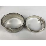 Two silver hinged bangles, each with foliate engraved faces, 44.8g (a/f)