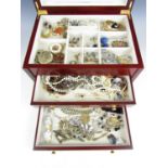 A vintage jewellery box containing a large quantity of costume jewellery, including clip on