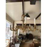 A large elaborate brass eight-branch chandelier