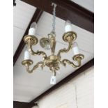 A small brass five-branch ceiling light
