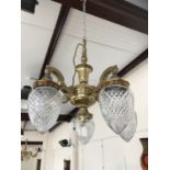 An early 20th Century brass electrolier with cut glass shades (one shade a/f)