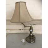 A contemporary brushed metal adjustable table lamp