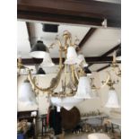 A large multi-branch brass pendant ceiling light with marbled glass shades