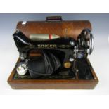 An early 20th Century Singer sewing machine, with original instruction manual