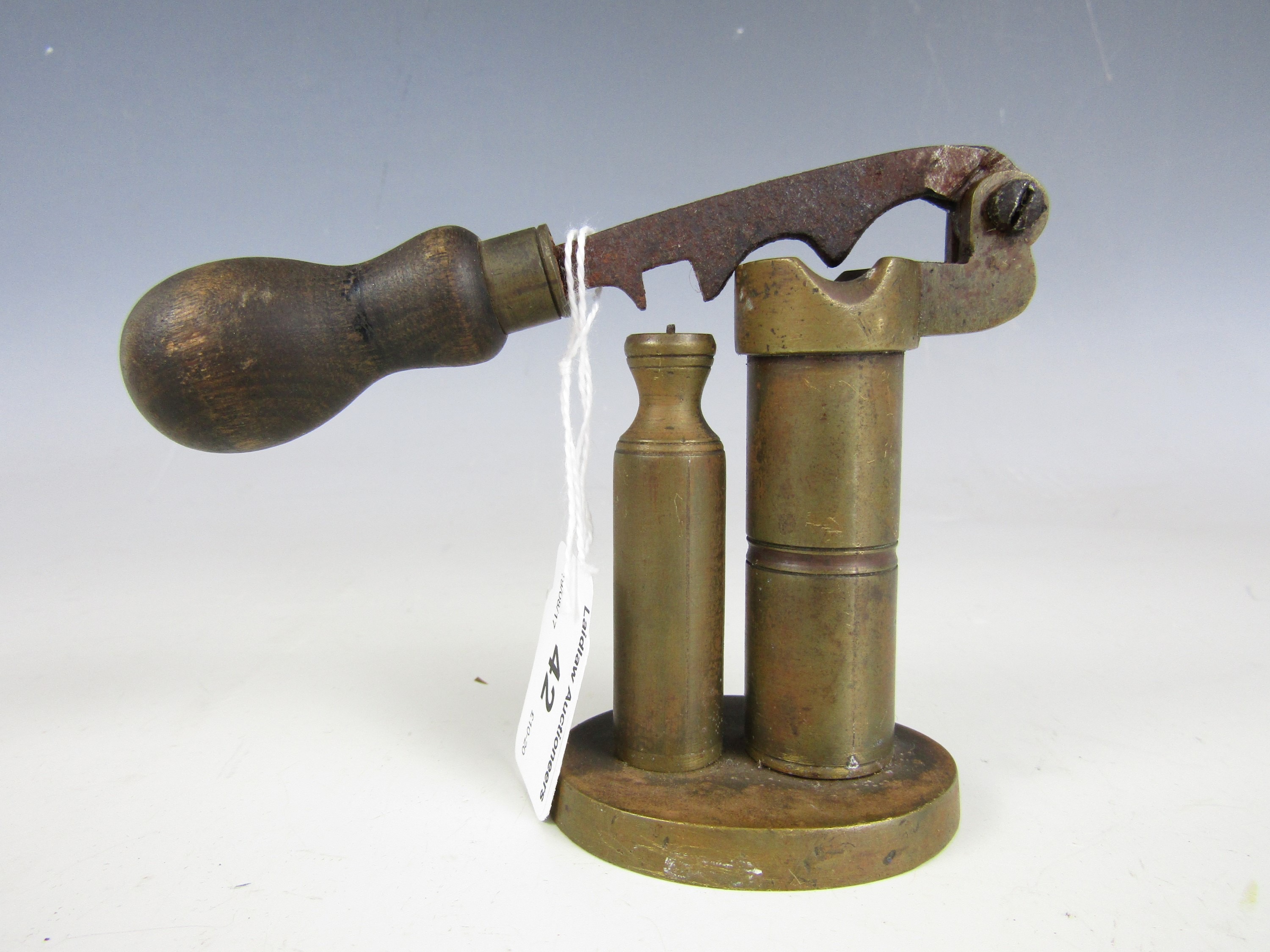 An antique brass shot gun cartridge capping / de-capping tool