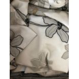A complete bedroom suite of soft furnishings in voile with black and cream trimmed appliqué flower
