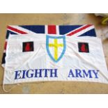 A large Union Jack flag together with an 8th army flag