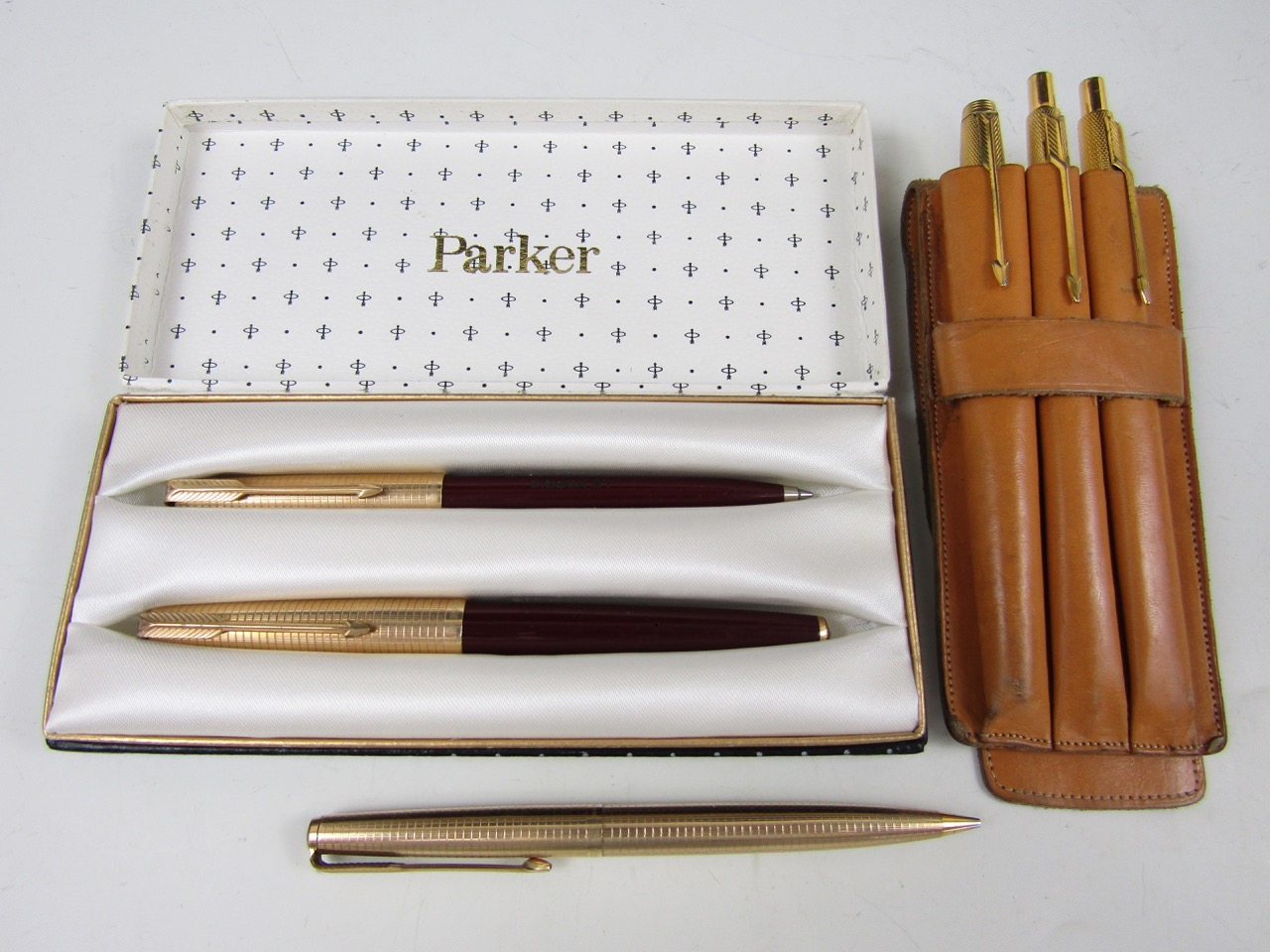 A cased 1960s Parker rolled-gold fountain and ball-point pen set, together with a similar set and