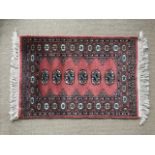 An Indian woven wool rug in pink blue and green, 91 x 63 cm (2)