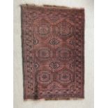 An oriental hand woven rug in earth copper and red, 113 x 78 cm (1)