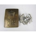 A 74th Highlanders brass shoulder plate and a Cameronians cap badge